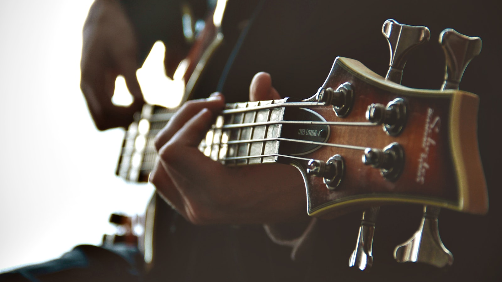 Hands playing chords on an electric piano in a softly lit home studio